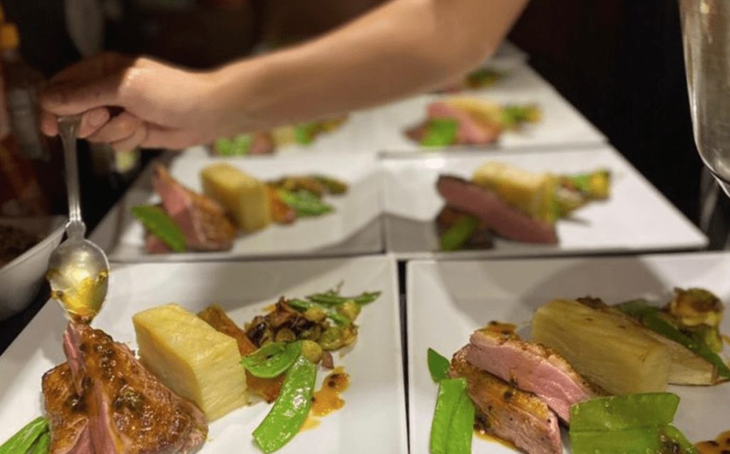 yacht chef Katie plating up the guest meals